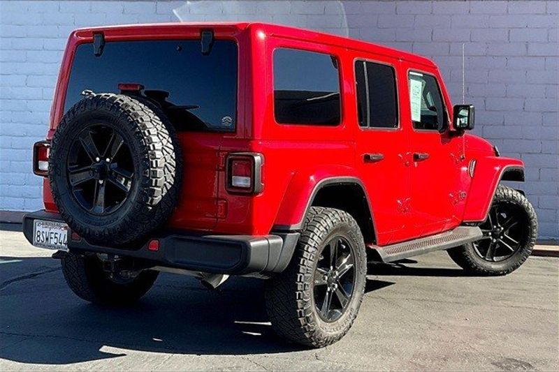 2021 Jeep Wrangler Unlimited Sahara Altitude in a Firecracker Red Clear Coat exterior color and Blackinterior. I-10 Chrysler Dodge Jeep Ram (760) 565-5160 pixelmotiondemo.com 