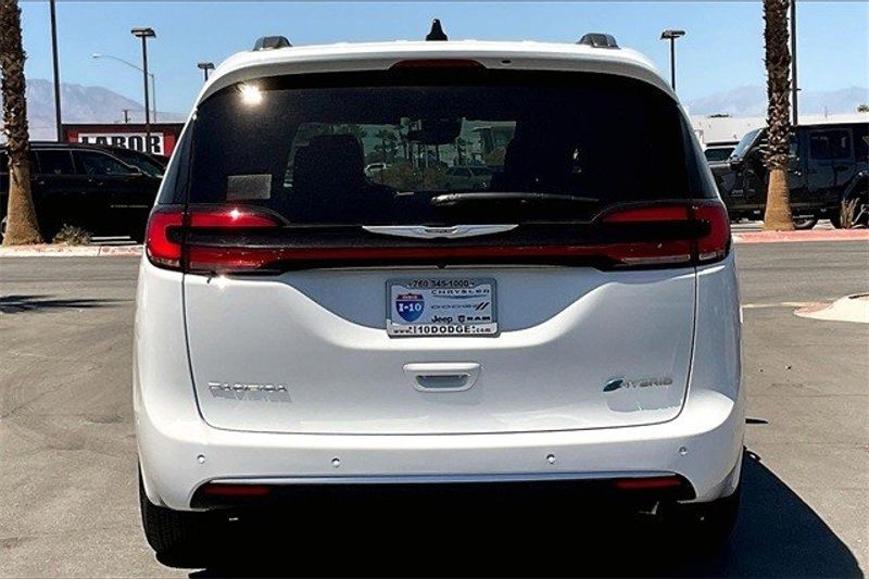 2023 Chrysler Pacifica Plug-in Hybrid Pinnacle in a Bright White Clear Coat exterior color and Blackinterior. I-10 Chrysler Dodge Jeep Ram (760) 565-5160 pixelmotiondemo.com 