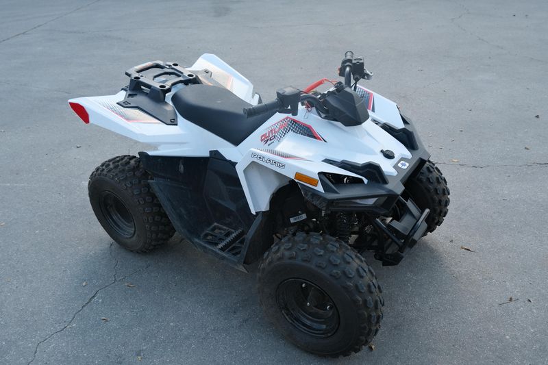 Used 2023 Polaris OUTLAW 70 EFI BRIGHT WHITE AND RED Image 1