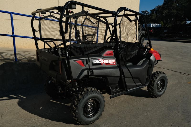 NEW 2026 HONDA PIONEER 7004  in a HERO RED exterior color. Family PowerSports (877) 886-1997 familypowersports.com