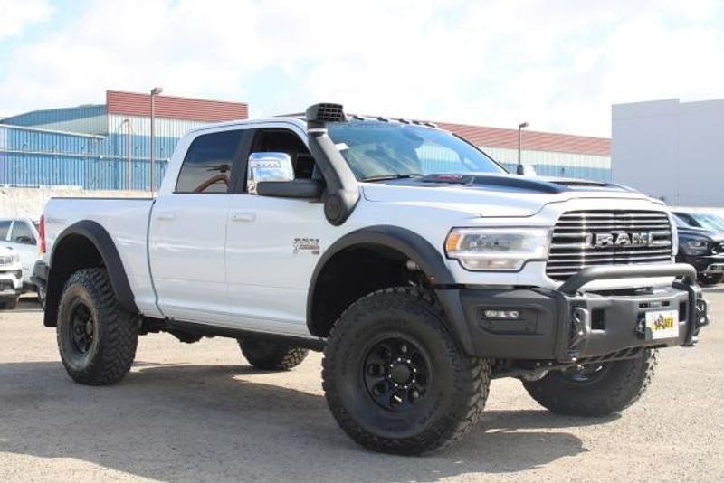 2023 RAM 2500 Laramie Crew Cab 4x4 in a Bright White exterior color and Blackinterior. BEACH BLVD OF CARS beachblvdofcars.com 