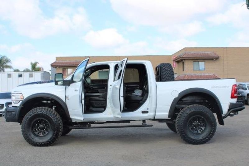 2023 RAM 2500 Laramie Crew Cab 4x4 in a Bright White exterior color and Blackinterior. BEACH BLVD OF CARS beachblvdofcars.com 