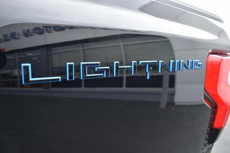2023 Ford F-150 Lightning XLT in a Agate Black Metallic exterior color and Medium Dark Slateinterior. BEACH BLVD OF CARS beachblvdofcars.com 