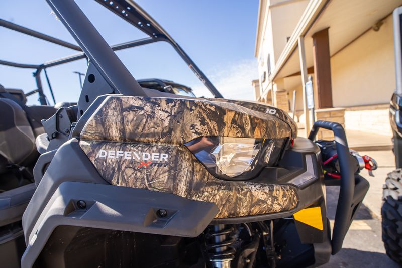 2024 CAN-AM DEFENDER MAX X MR HD10 CAMO WILDLAND in a CAMO exterior color. Family PowerSports (877) 886-1997 familypowersports.com 