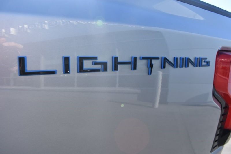 2023 Ford F-150 Lightning XLT in a Iconic Silver Metallic exterior color and Medium Dark Slateinterior. BEACH BLVD OF CARS beachblvdofcars.com 
