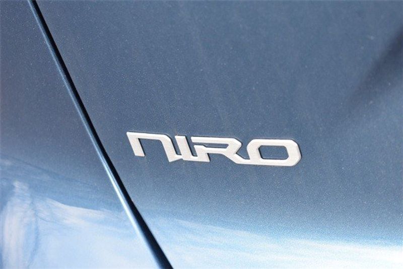2024 Kia Niro SX Touring in a Mineral Blue exterior color and Medium Grayinterior. Raymond Auto Group 888-703-9950 raymonddeals.com 