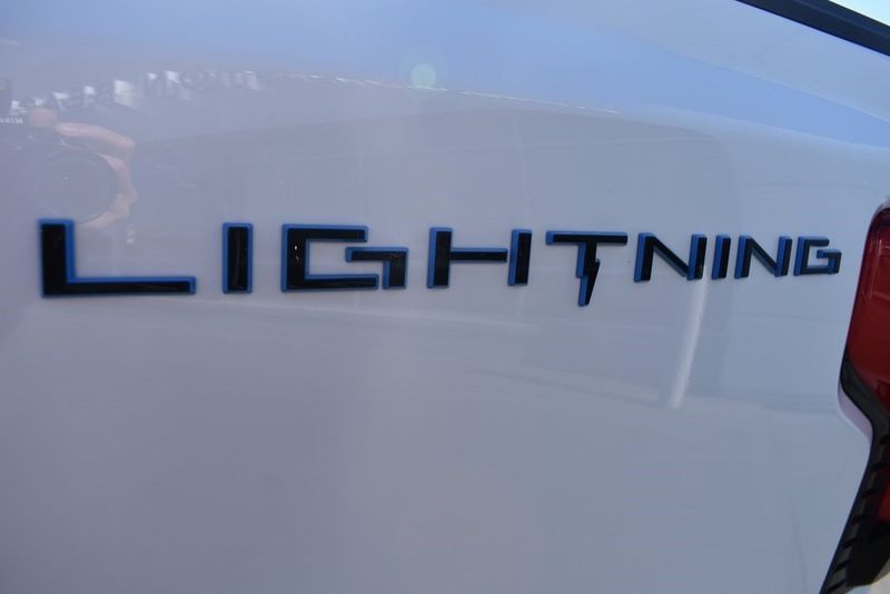 2023 Ford F-150 Lightning Lariat in a White Metallic exterior color and Blackinterior. BEACH BLVD OF CARS beachblvdofcars.com 
