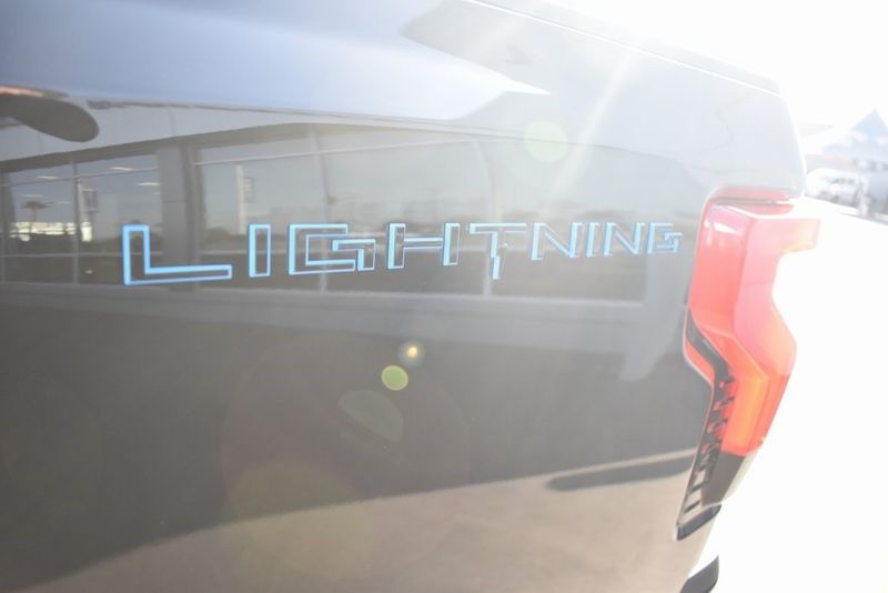 2023 Ford F-150 Lightning Lariat in a Agate Black Metallic exterior color and Blackinterior. BEACH BLVD OF CARS beachblvdofcars.com 