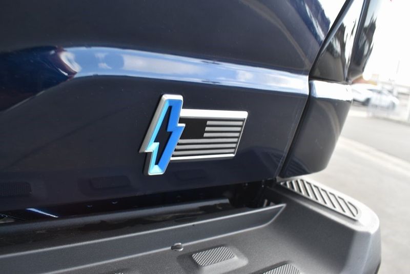 2023 Ford F-150 Lightning Lariat in a Antimatter Blue Metallic exterior color and Blackinterior. BEACH BLVD OF CARS beachblvdofcars.com 