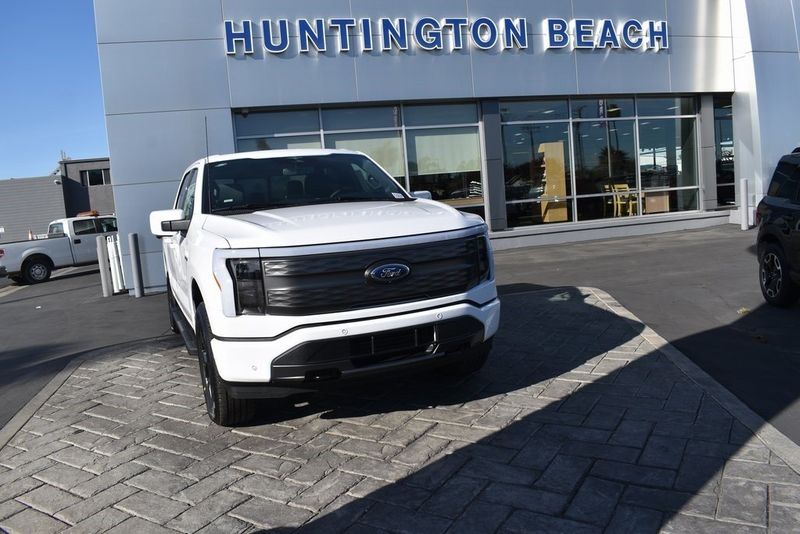 2023 Ford F-150 Lightning Lariat in a Oxford White exterior color and Blackinterior. BEACH BLVD OF CARS beachblvdofcars.com 