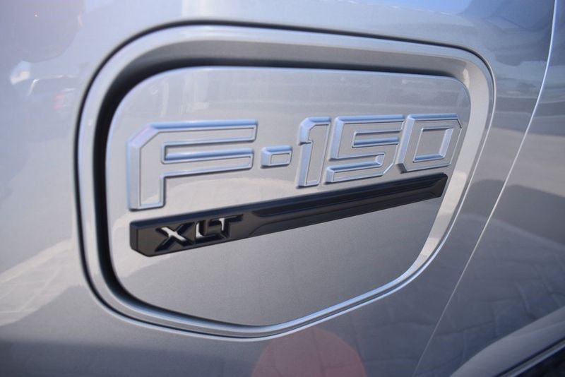 2023 Ford F-150 Lightning XLT in a Iconic Silver Metallic exterior color and Medium Dark Slateinterior. BEACH BLVD OF CARS beachblvdofcars.com 