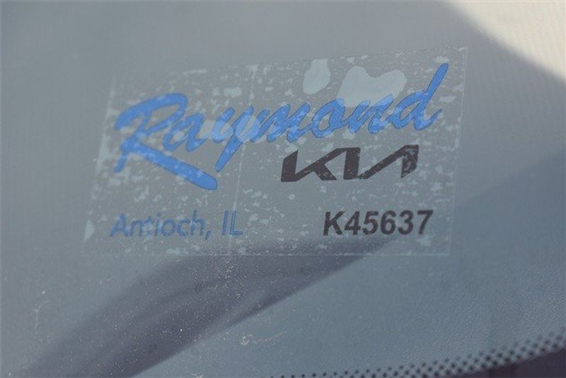 2024 Kia Niro EX Touring in a Runway Red exterior color and Grayinterior. Raymond Auto Group 888-703-9950 raymonddeals.com 