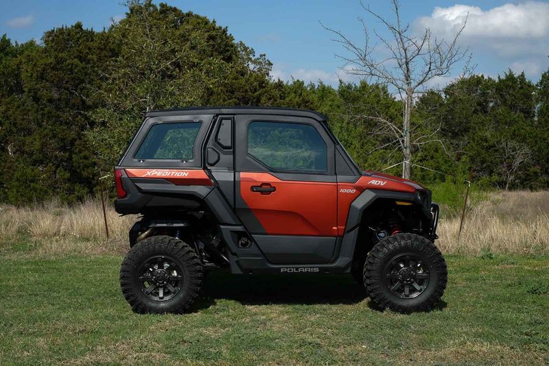 2024 POLARIS XPEDITION ADV 1000 NSTR Matte Orange Rust in a ORANGE exterior color. Family PowerSports (877) 886-1997 familypowersports.com 