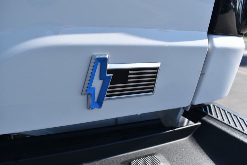 2023 Ford F-150 Lightning XLT in a Oxford White exterior color and Medium Dark Slateinterior. BEACH BLVD OF CARS beachblvdofcars.com 