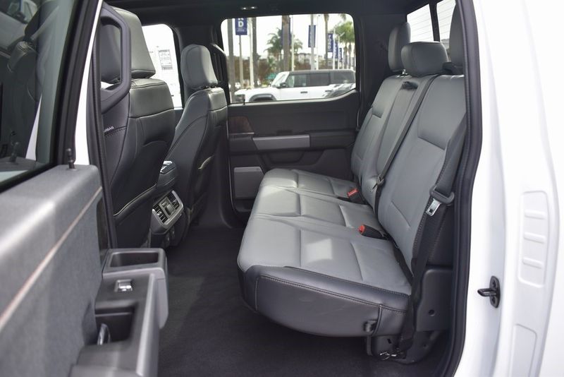2023 Ford F-150 Lightning Lariat in a Oxford White exterior color and Blackinterior. BEACH BLVD OF CARS beachblvdofcars.com 