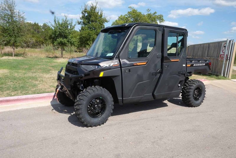 2024 POLARIS RANGER CREW XP 1000 NORTHSTAR ULTIMATE  SUPER GRAPHITE WITH ORANGE BURST ACCENTS in a GRAY exterior color. Family PowerSports (877) 886-1997 familypowersports.com 