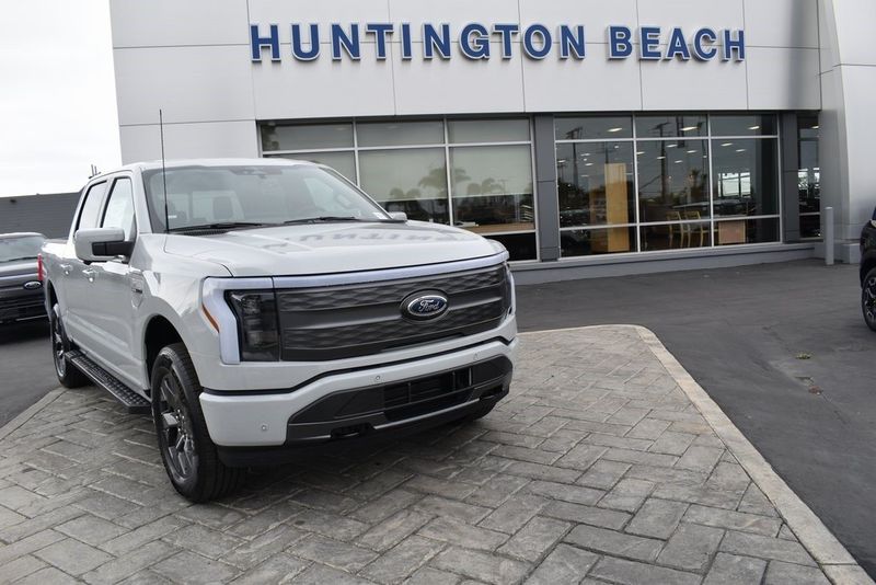 2023 Ford F-150 Lightning Lariat in a Avalanche exterior color and Blackinterior. BEACH BLVD OF CARS beachblvdofcars.com 