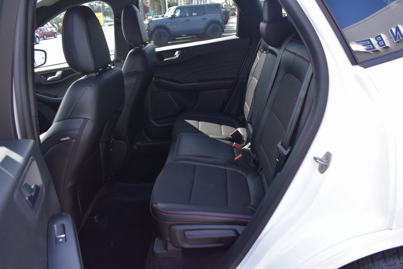 2023 Ford Escape ST-Line in a Star White Metallic Tri Coat exterior color and Ebony With Red Stitchinginterior. BEACH BLVD OF CARS beachblvdofcars.com 