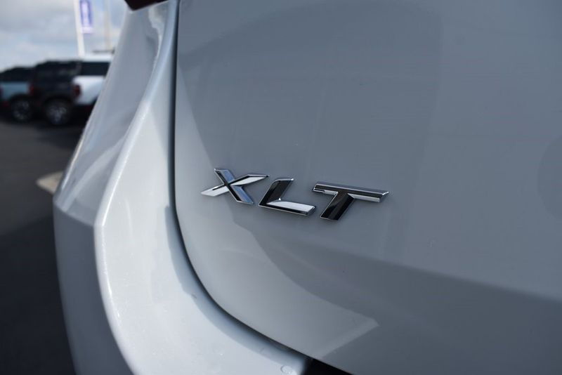 2023 Ford Explorer XLT in a Star White Metallic Tri Coat exterior color and Ebonyinterior. BEACH BLVD OF CARS beachblvdofcars.com 