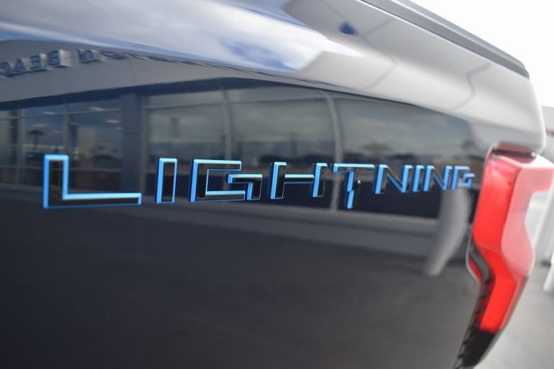 2023 Ford F-150 Lightning Lariat in a Antimatter Blue Metallic exterior color and Blackinterior. BEACH BLVD OF CARS beachblvdofcars.com 