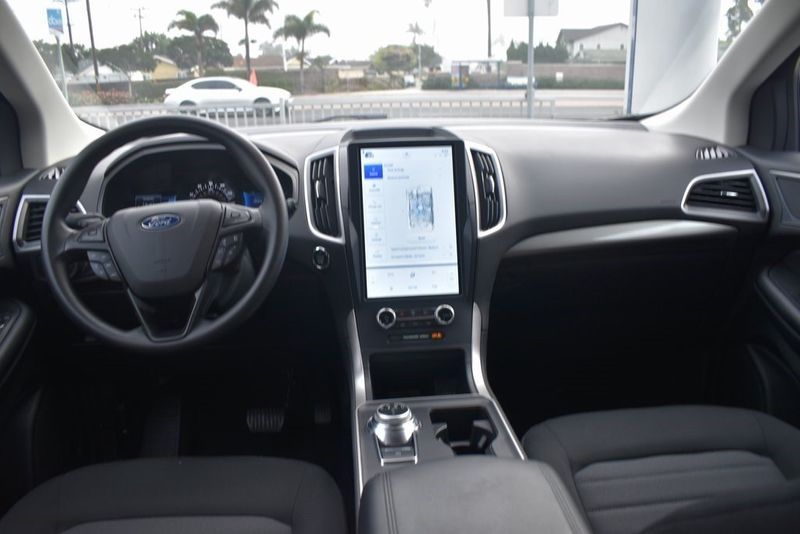 2023 Ford Edge SE in a Carbonized Gray Metallic exterior color and Ebonyinterior. BEACH BLVD OF CARS beachblvdofcars.com 