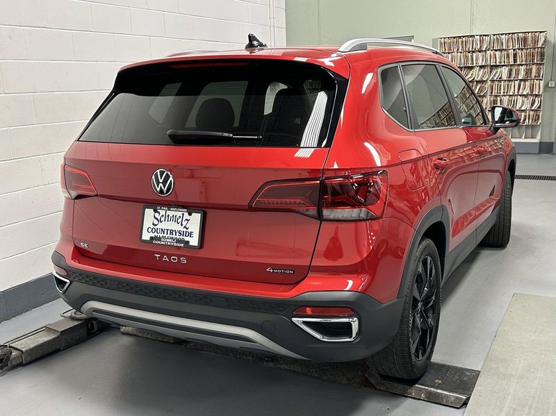 2023 Volkswagen Taos SE 4-Motion AWD w/Black Wheel Pkg in a Kings Red Metallic exterior color and Black heated seatsinterior. Schmelz Countryside Alfa Romeo (651) 867-3222 schmelzalfaromeo.com 