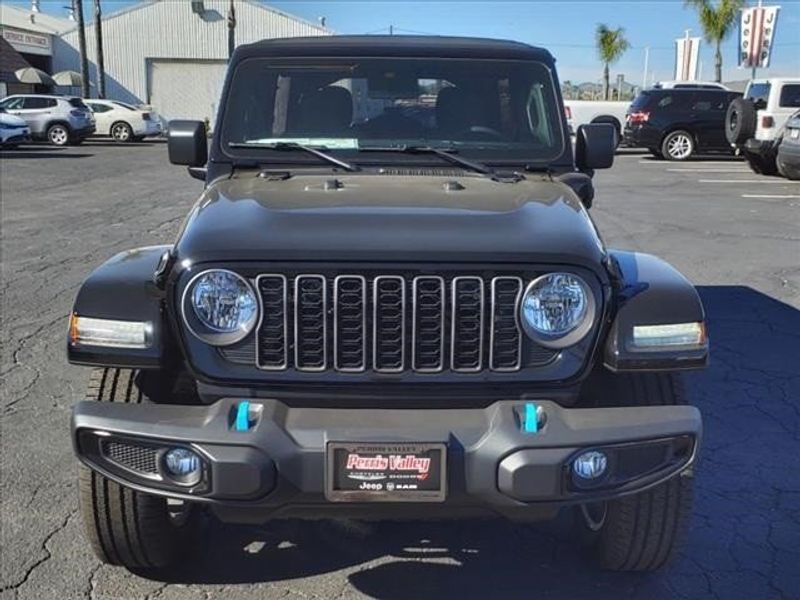 2024 Jeep Wrangler Sport S 4xe in a Black Clear Coat exterior color and Blackinterior. Perris Valley Auto Center 951-657-6100 perrisvalleyautocenter.com 