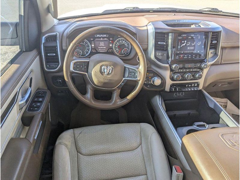 2021 RAM 1500 Laramie in a Bright White Clear Coat exterior color and Light Frost Beige/Mountain Browninterior. Johnson Dodge 601-693-6343 pixelmotiondemo.com 