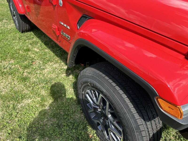 2024 Jeep Wrangler 4-door Sahara in a Firecracker Red Clear Coat exterior color. Gupton Motors Inc 615-384-2886 guptonmotors.com 