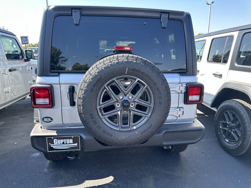 2024 Jeep Wrangler 4-door Sport S in a Silver Zynith Clear Coat exterior color and Blackinterior. CDJR of Anytown 949-555-4321 pixelmotiondemo.com 