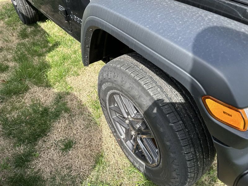 2024 Jeep Wrangler 4-door Sport S in a Black Clear Coat exterior color and Blackinterior. CDJR of Anytown 949-555-4321 pixelmotiondemo.com 