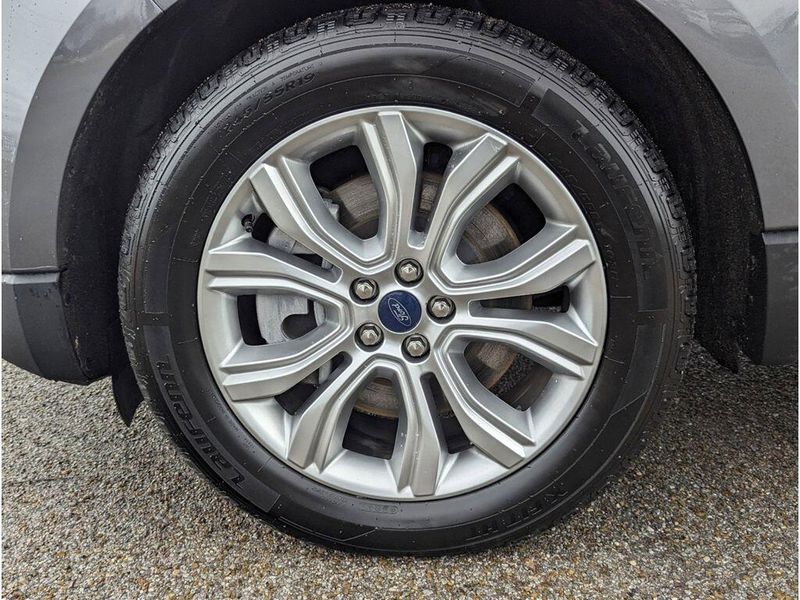 2022 Ford Edge Titanium in a Carbonized Gray Metallic exterior color and Medium Soft Ceramicinterior. Johnson Dodge 601-693-6343 pixelmotiondemo.com 