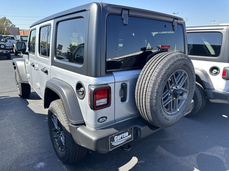 2024 Jeep Wrangler 4-door Sport S in a Silver Zynith Clear Coat exterior color and Blackinterior. CDJR of Anytown 949-555-4321 pixelmotiondemo.com 