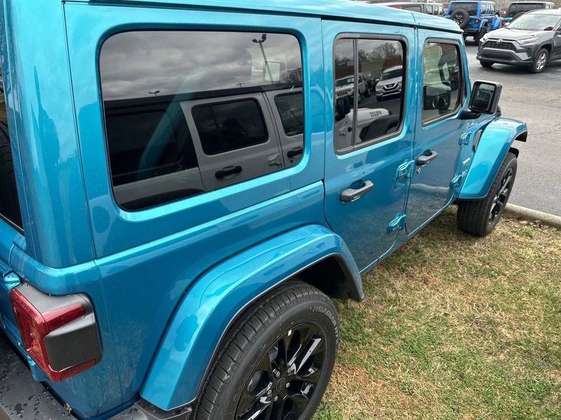 2024 Jeep Wrangler 4-door Sahara 4xe in a Bikini Pearl Coat exterior color. Gupton Motors Inc 615-384-2886 guptonmotors.com 