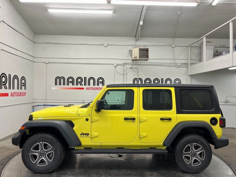 2023 Jeep Wrangler 4-door Sport S 4x4 in a High Velocity Clear Coat exterior color and Blackinterior. Marina Chrysler Dodge Jeep RAM (855) 616-8084 marinadodgeny.com 