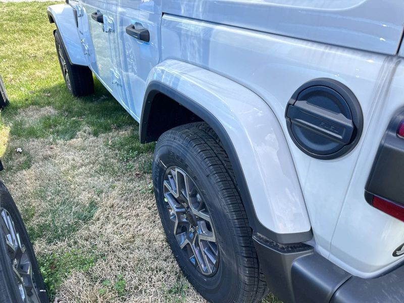 2024 Jeep Wrangler 4-door Sahara in a Bright White Clear Coat exterior color. Gupton Motors Inc 615-384-2886 guptonmotors.com 