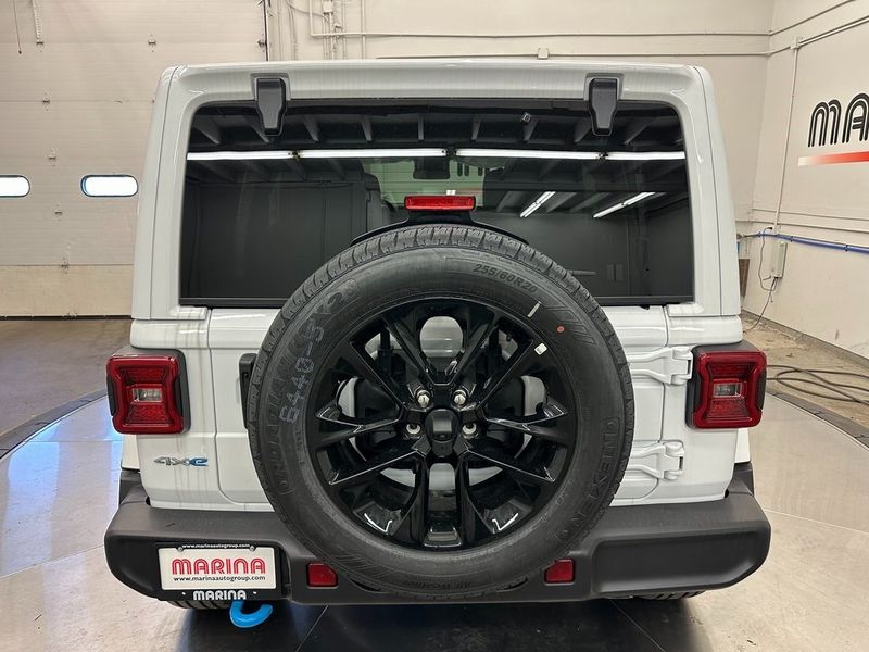 2024 Jeep Wrangler 4-door Sahara 4xe in a Bright White Clear Coat exterior color. Marina Auto Group (855) 564-8688 marinaautogroup.com 