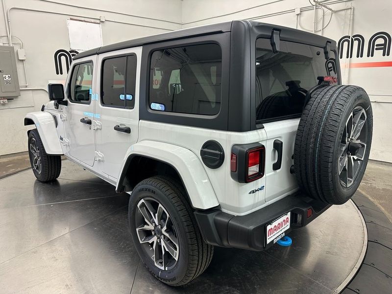 2024 Jeep Wrangler 4-door Sport S 4xe in a Bright White Clear Coat exterior color and Blackinterior. Marina Chrysler Dodge Jeep RAM (855) 616-8084 marinadodgeny.com 