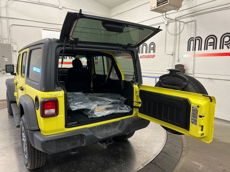 2023 Jeep Wrangler 4-door Sport S 4x4 in a High Velocity Clear Coat exterior color and Blackinterior. Marina Chrysler Dodge Jeep RAM (855) 616-8084 marinadodgeny.com 