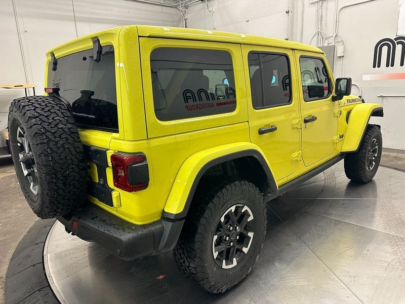 2024 Jeep Wrangler 4-door Rubicon X 4xe in a High Velocity Clear Coat exterior color and Blackinterior. Marina Chrysler Dodge Jeep RAM (855) 616-8084 marinadodgeny.com 