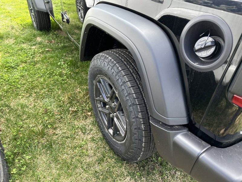 2024 Jeep Wrangler 4-door Sport S in a Black Clear Coat exterior color and Blackinterior. CDJR of Anytown 949-555-4321 pixelmotiondemo.com 