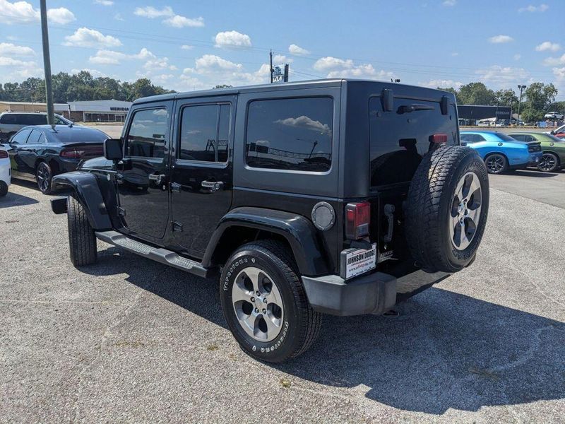 2017 Jeep Wrangler Unlimited Sahara in a Black Clear Coat exterior color and Blackinterior. Johnson Dodge 601-693-6343 pixelmotiondemo.com 