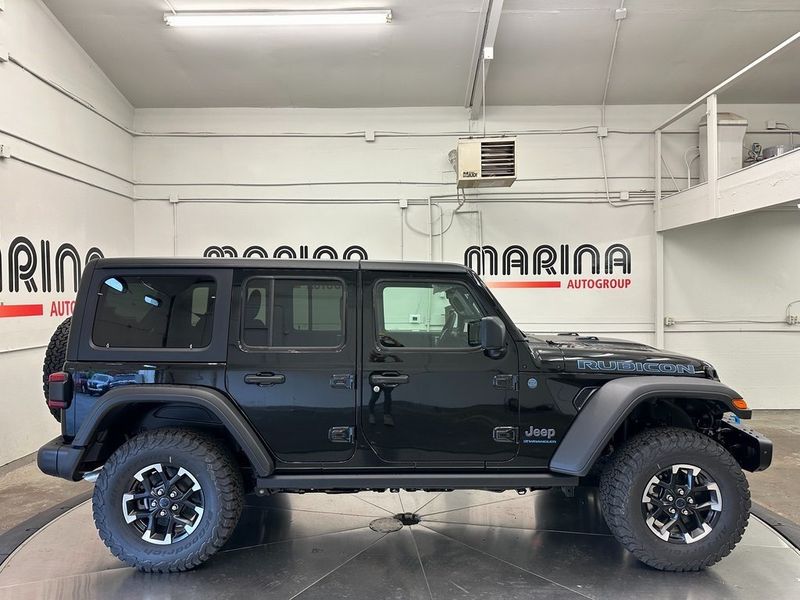 2024 Jeep Wrangler 4-door Rubicon 4xe in a Black Clear Coat exterior color and Blackinterior. Marina Chrysler Dodge Jeep RAM (855) 616-8084 marinadodgeny.com 