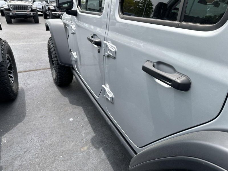 2024 Jeep Wrangler 4-door Willys in a Silver Zynith Clear Coat exterior color and Blackinterior. CDJR of Anytown 949-555-4321 pixelmotiondemo.com 