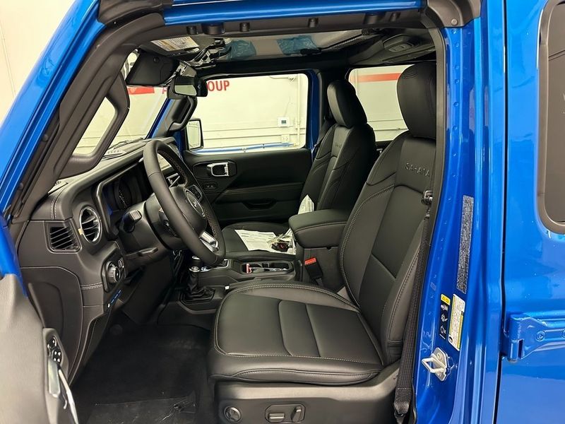 2024 Jeep Wrangler 4-door Sahara 4xe in a Hydro Blue Pearl Coat exterior color and Blackinterior. Marina Chrysler Dodge Jeep RAM (855) 616-8084 marinadodgeny.com 