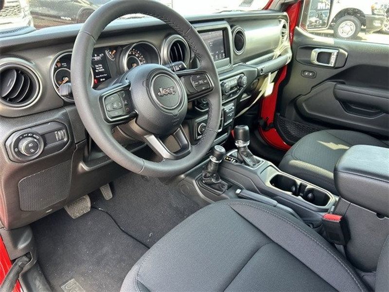 2023 Jeep Gladiator Sport S 4x4 in a Firecracker Red Clear Coat exterior color and Blackinterior. McPeek