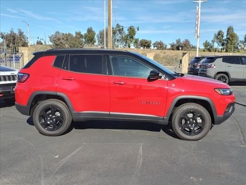 2024 Jeep Compass Trailhawk in a Prm exterior color and Ruby Red/Blackinterior. Perris Valley Auto Center 951-657-6100 perrisvalleyautocenter.com 