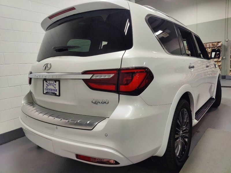 2023 INFINITI QX80 Sensory in a Moonstone White exterior color and Saddle Browninterior. Schmelz Countryside Alfa Romeo and Fiat (651) 968-0556 schmelzfiat.com 