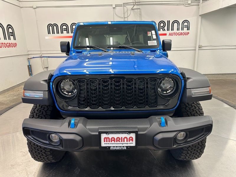 2024 Jeep Wrangler 4-door Willys 4xe in a Hydro Blue Pearl Coat exterior color and Blackinterior. Marina Chrysler Dodge Jeep RAM (855) 616-8084 marinadodgeny.com 