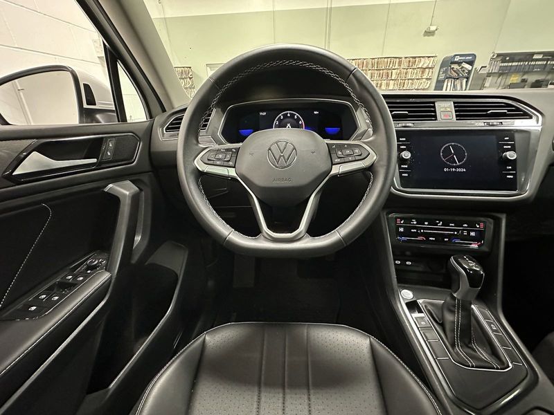 2023 Volkswagen Tiguan SE w/Sunroof & 3rd Row in a Opal White Pearl exterior color and Black Heated Seatsinterior. Schmelz Countryside Alfa Romeo (651) 867-3222 schmelzalfaromeo.com 